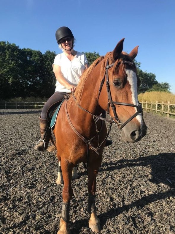 Julie on a brown horse.