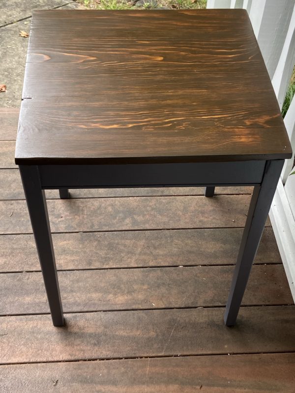 square table with a stained top.