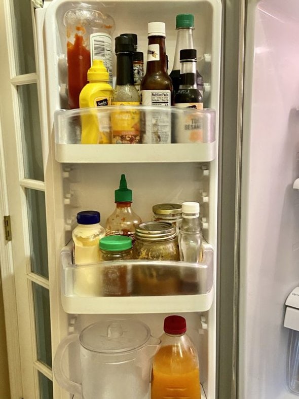 door with shelves of condiments.