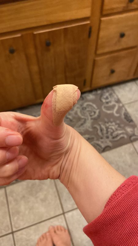 band-aid on thumb.