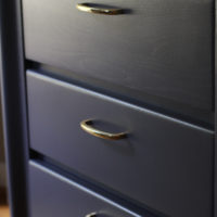 nightstand with gold handles.
