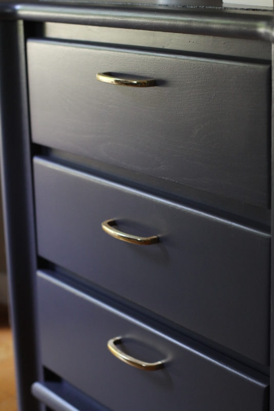 nightstand with gold handles.