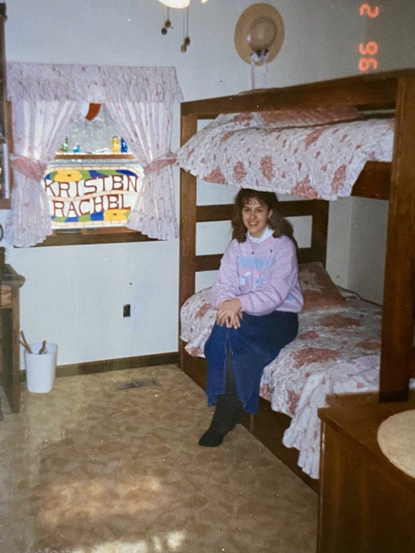 Kristen sittin on a bottom bunk.