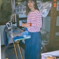 Kristen standing next to an ironing board.