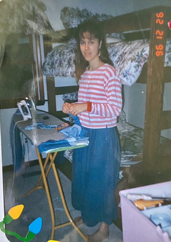 Kristen standing next to an ironing board.