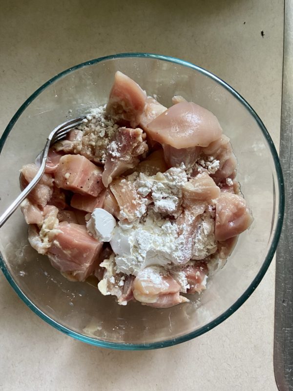 chicken in a bowl with cornstarch.