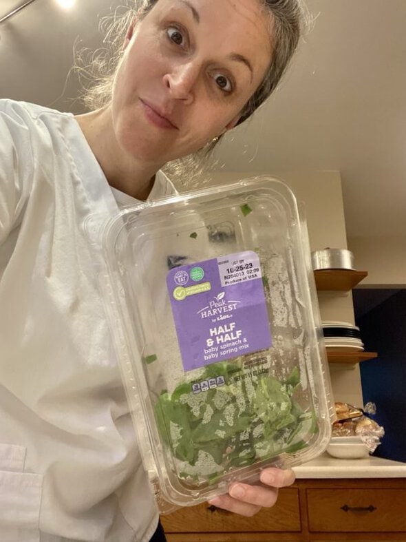 Kristen with a box of greens.