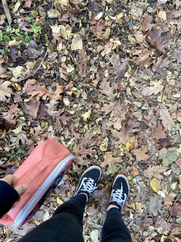 Kristen's feet on a path in the woods.