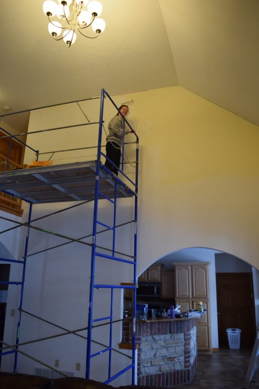 woman on scaffolding in a foyer.