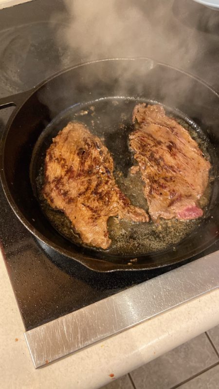 steak in a skillet.