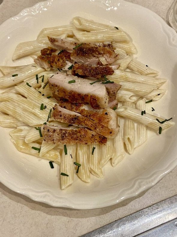 pasta topped with chicken.