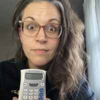 Kristen holding a calculator.