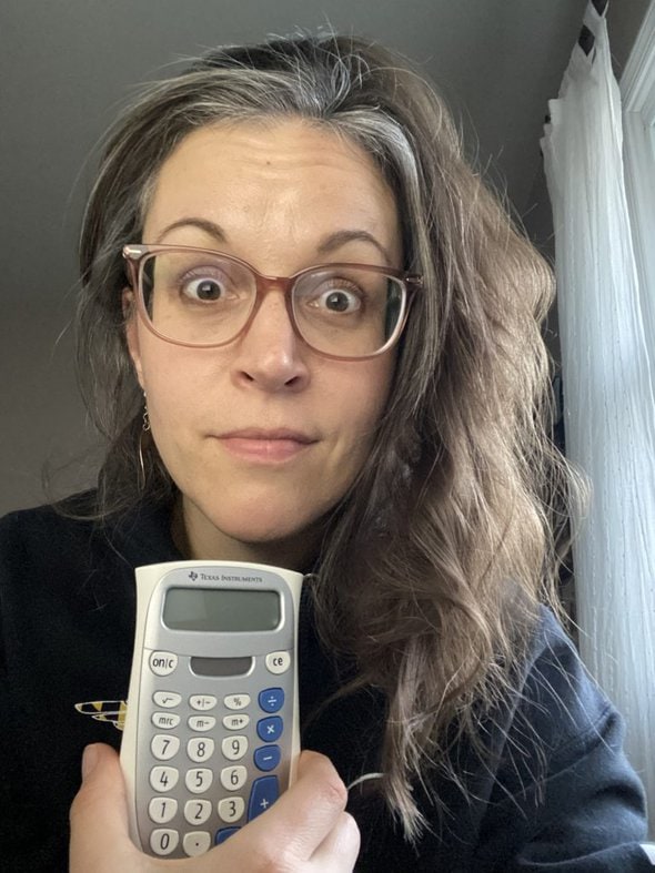 Kristen holding a calculator.