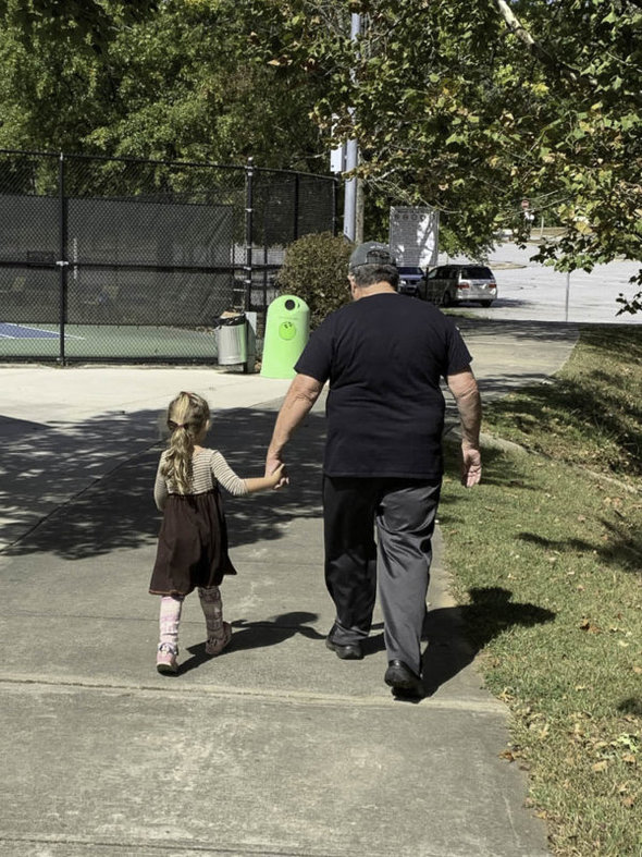 grandpa walking with granddaughter.