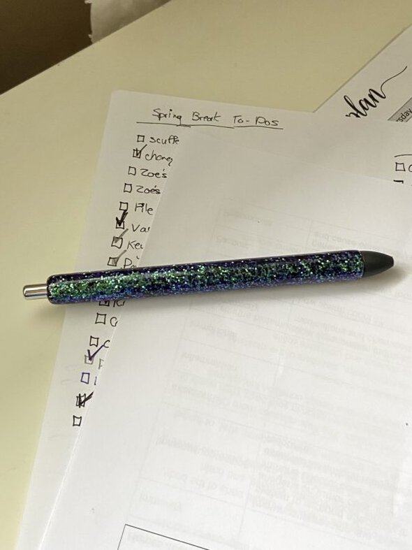 to-do list with a sparkly pen on top of it.