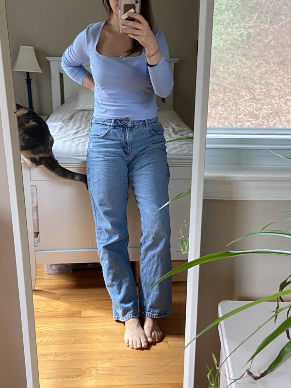 Kristen in jeans and a blue shirt.