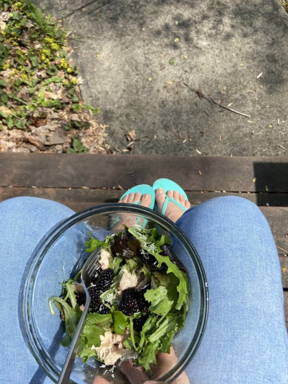 bowl of salad in Kristen's lap.