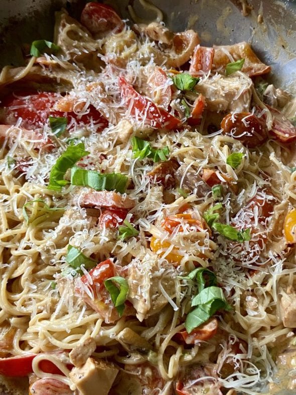 pasta dish topped with parmesan and basil.