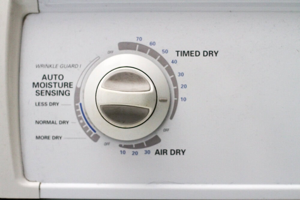 control panel on a white clothes dryer.
