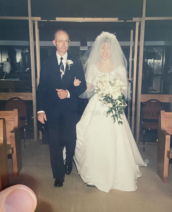 Kristen walking down wedding aisle.