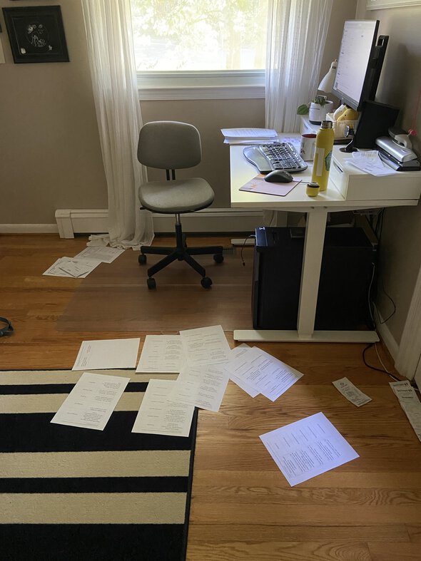 an office with papers on the floor.
