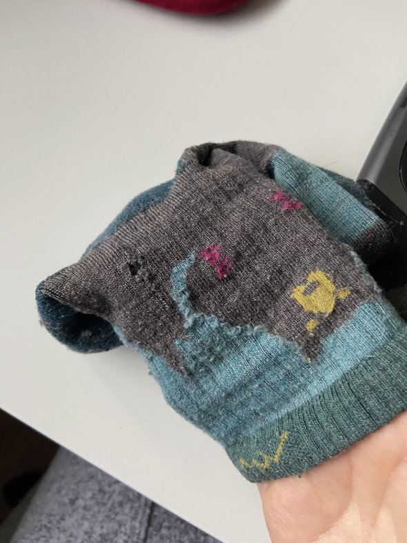 darn tough sock with hole.