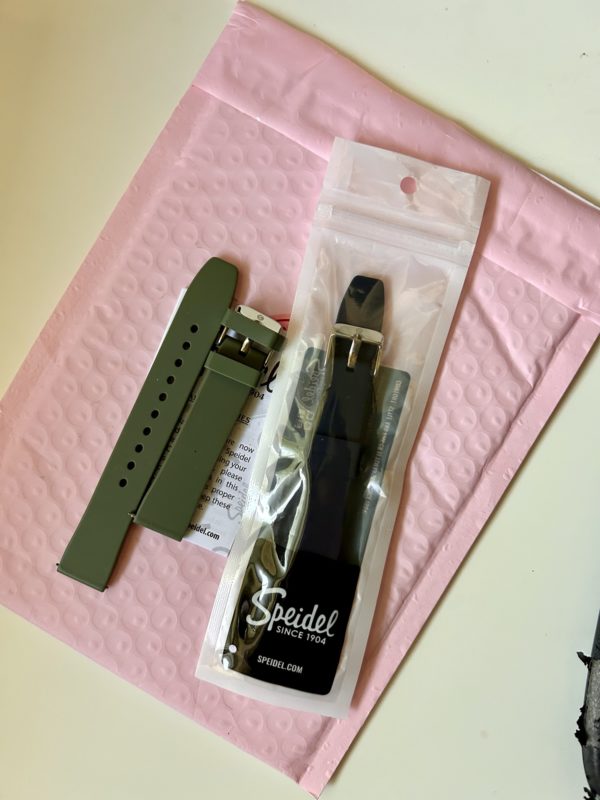 watch bands on a pink package.