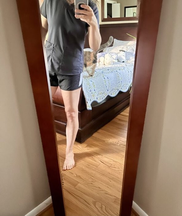 Kristen in shorts and a scrub top.