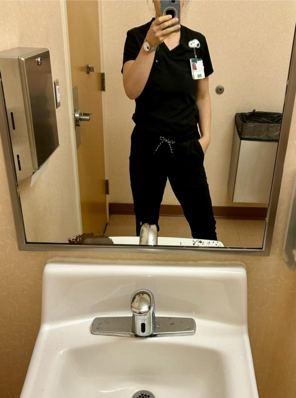 Kristen in black scrubs.