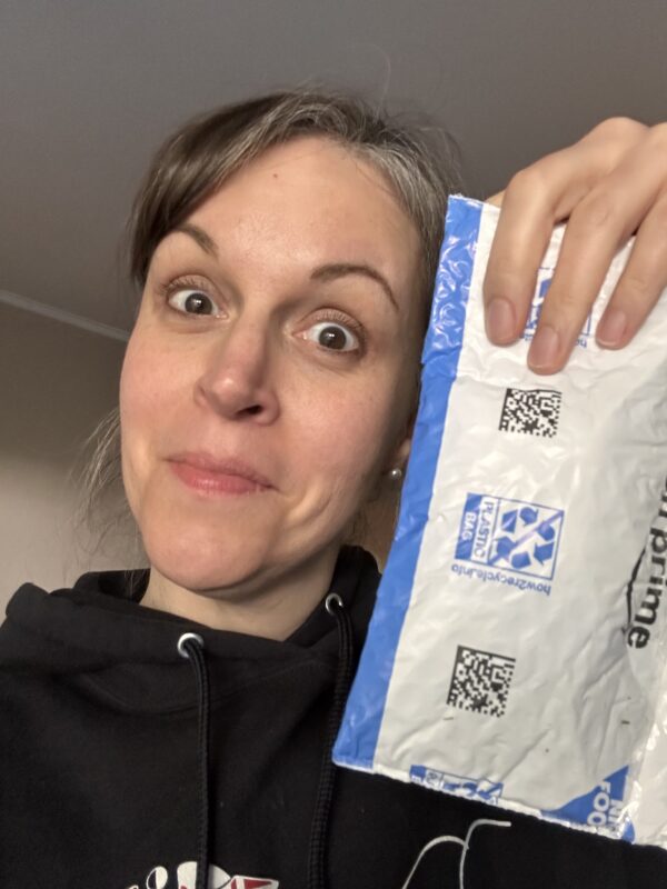 Kristen holding a package.