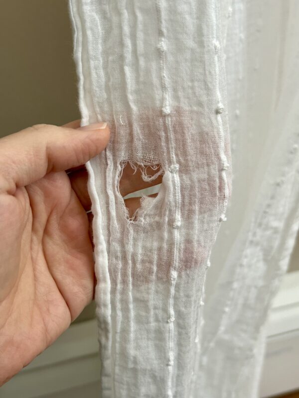 hole in curtain.