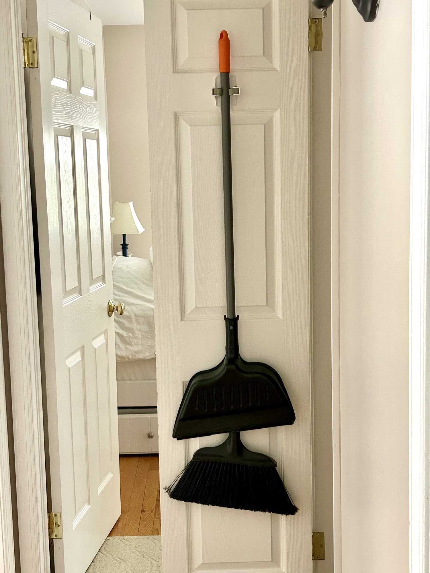 broom hanging on door.