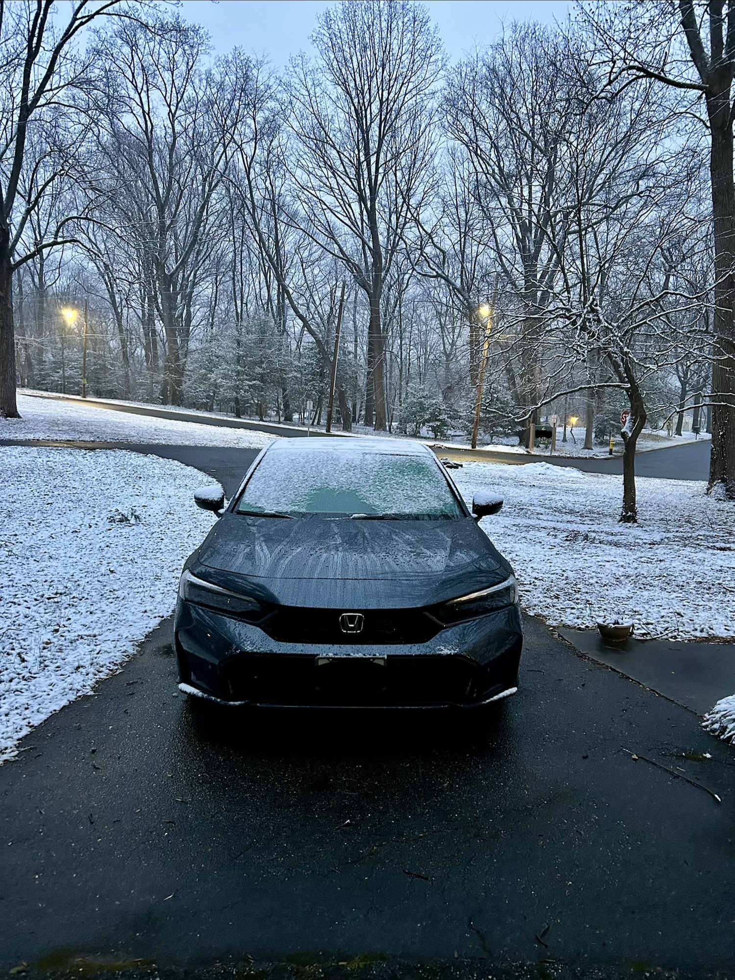car on driveway in the snow.