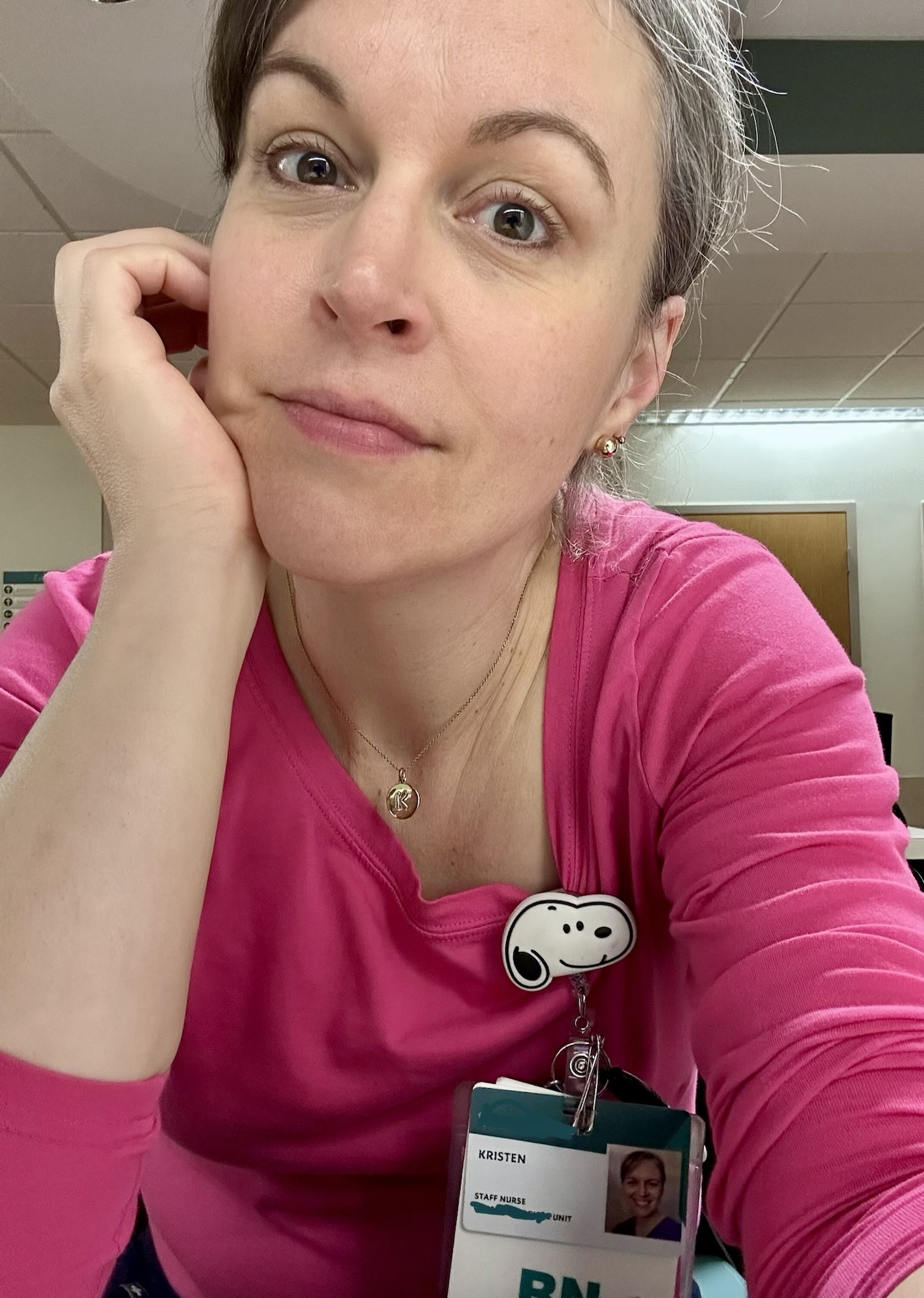 Kristen at work in a pink shirt.