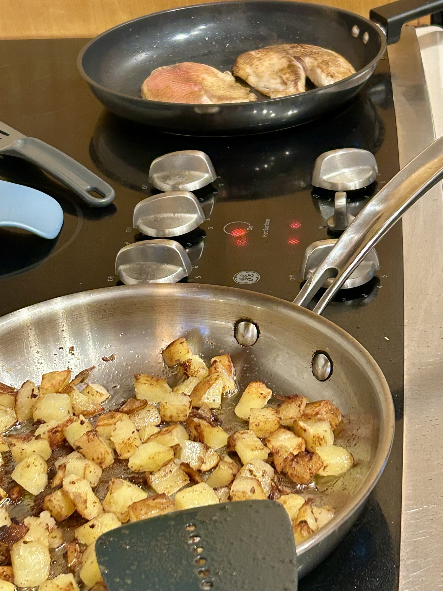 fish and potatoes on a stovetop.