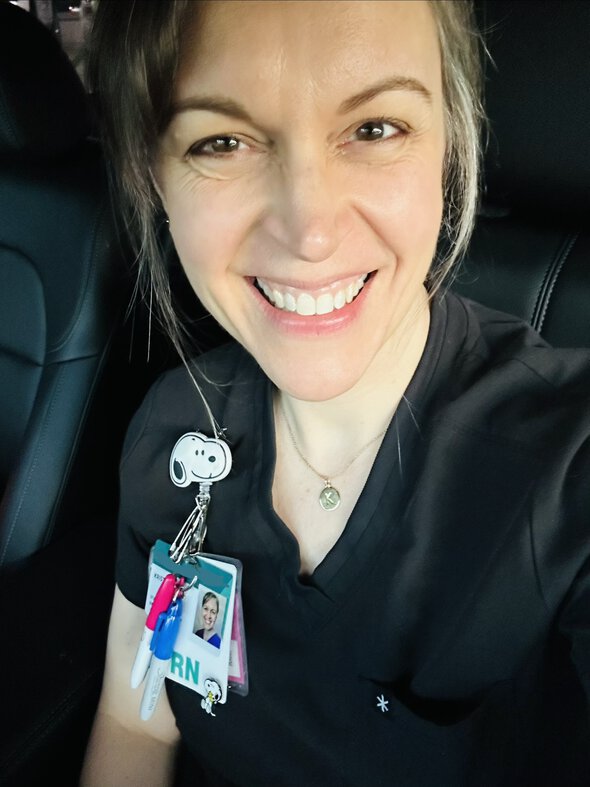 Kristen in black scrubs.