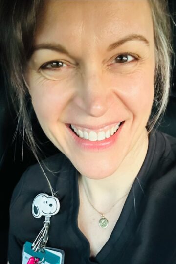 Kristen in black scrubs.