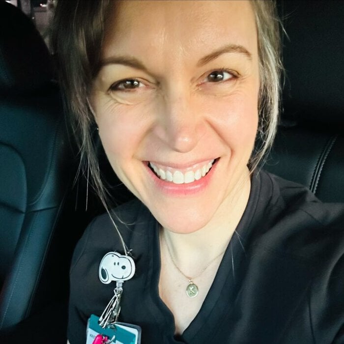 Kristen in black scrubs.