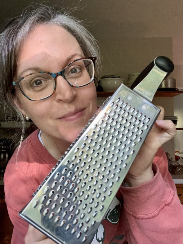 Kristen holding a box grater.