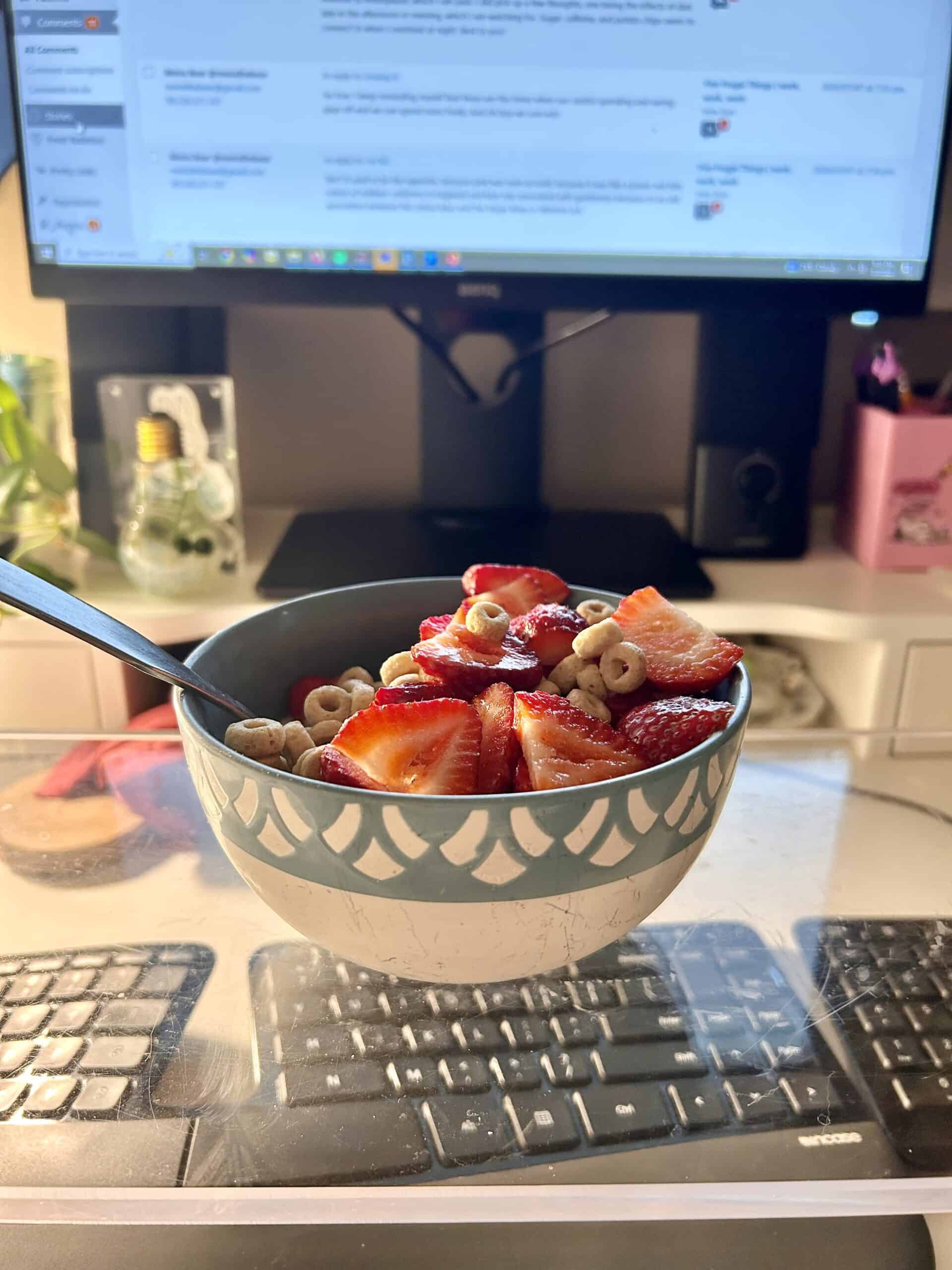 cheerios and strawberries in a bowl.