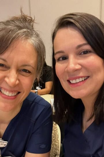 two nurses in blue scrubs.