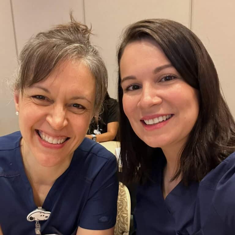 two nurses in blue scrubs.