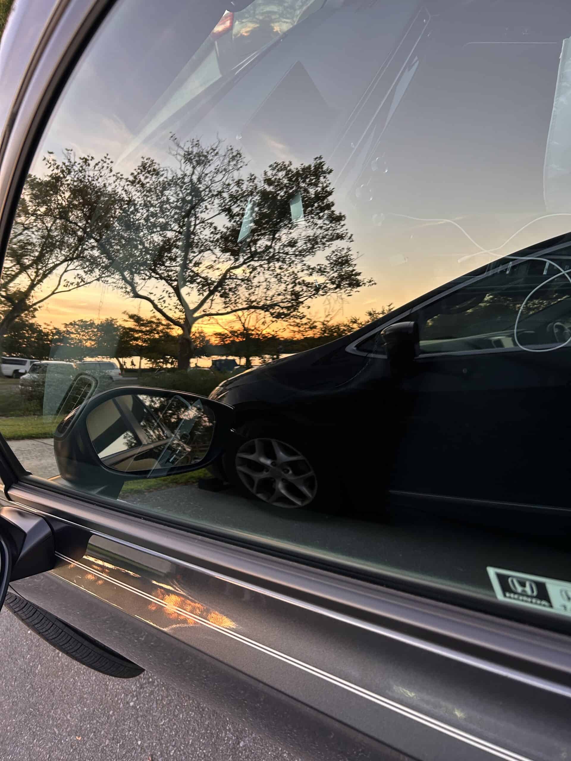 sunset reflection in car window.