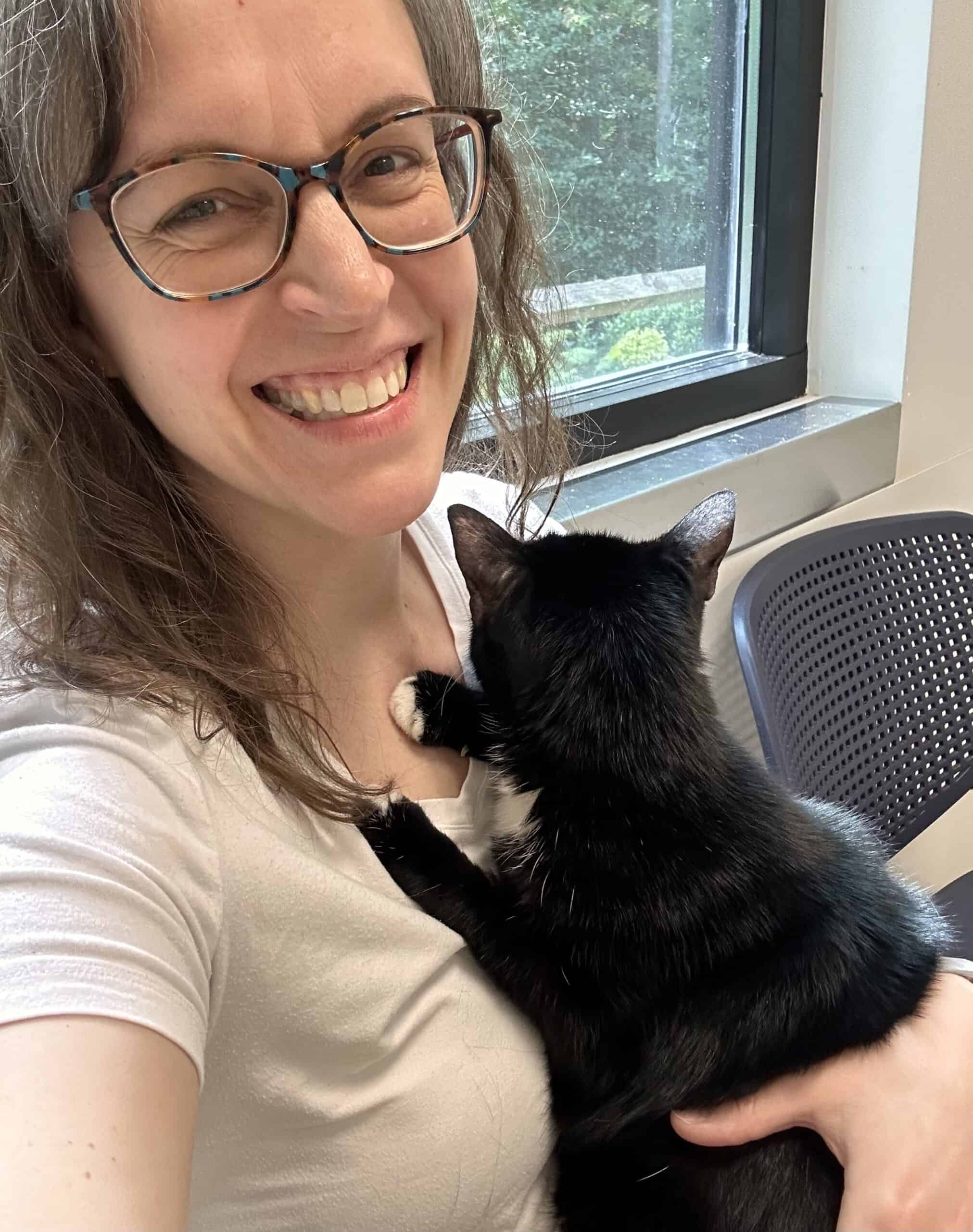 Kristen holding black cat.