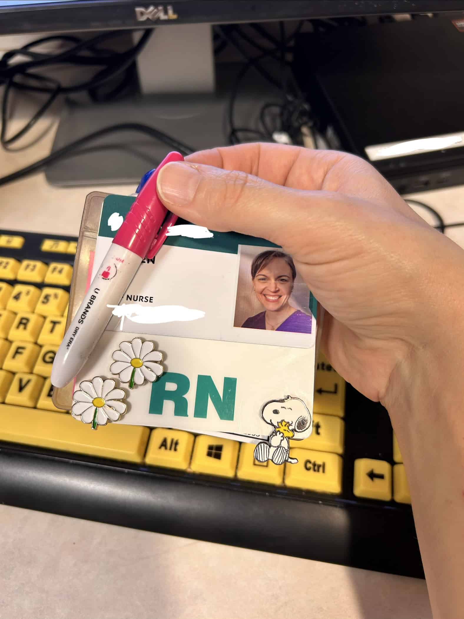 Daisy pins on nursing badge.
