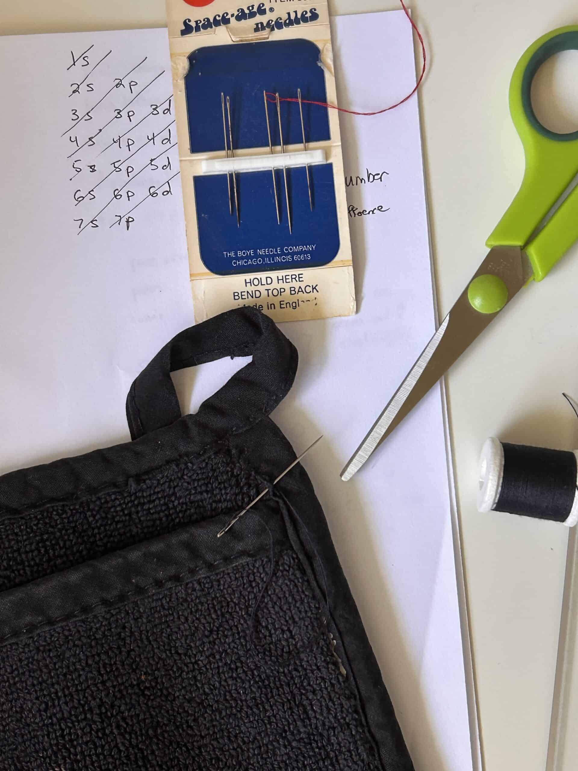 hand-mending a potholder.